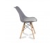 A modern chair with a velvet gray cushion on wooden beech legs, several colors